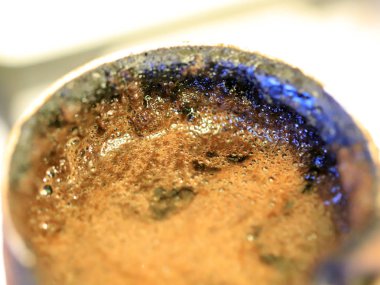 coffee foam on the surface of the drink during preparation