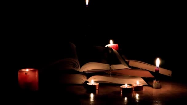 用燃烧的蜡烛和金色十字架点燃的老教堂书籍 — 图库视频影像