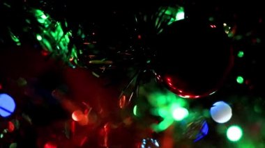 Noel ağacının dallarında şenlikli aydınlatma ve cam oyuncaklar