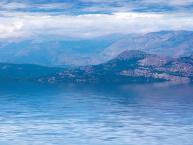 okyanus yüzeyinin sakin su dağ zirvelerinin yansıması