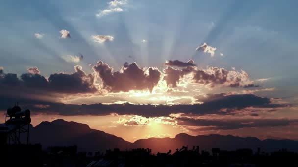 Красивые Солнечные Лучи Облачном Небе Над Крышами Городских Зданий — стоковое видео
