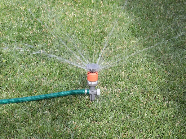 芝生に水をやるとき 噴霧器を通る水の流れ — ストック写真