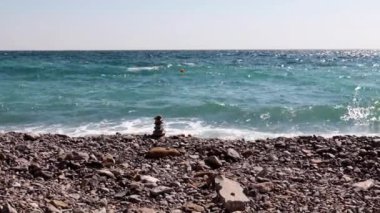 sahilde taş piramit ve deniz dalgaları