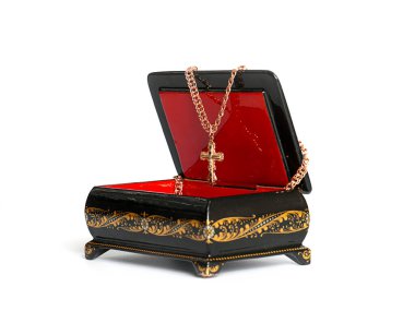 Süslü bir kutuda altın haç, zarif mücevherler.