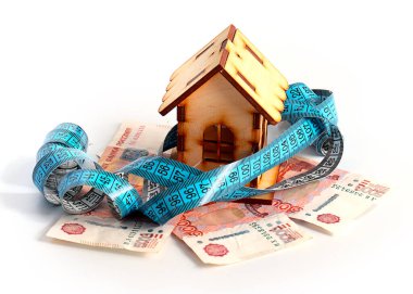 Ev bir banknotun üzerinde Rus rublesi ve bir mezura var.