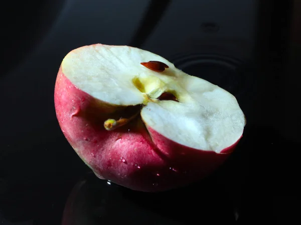 half ripe apple and a drop of pure water