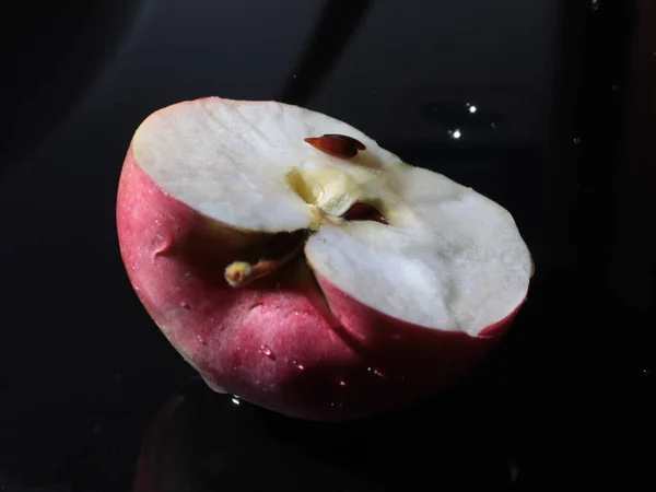 half ripe apple and a drop of pure water