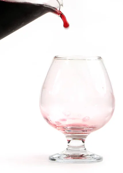 Ein Wasserstrahl Und Tropfen Rotwein Beim Befüllen Eines Glases — Stockfoto