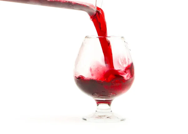 Ένα Ποτήρι Κόκκινο Κρασί Και Ένα Πίδακα Υγρού — Φωτογραφία Αρχείου