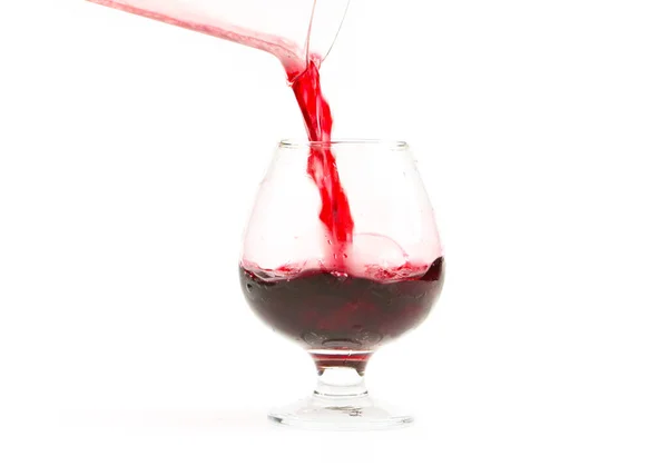 Ein Glas Rotwein Und Ein Strahl Flüssigkeit — Stockfoto
