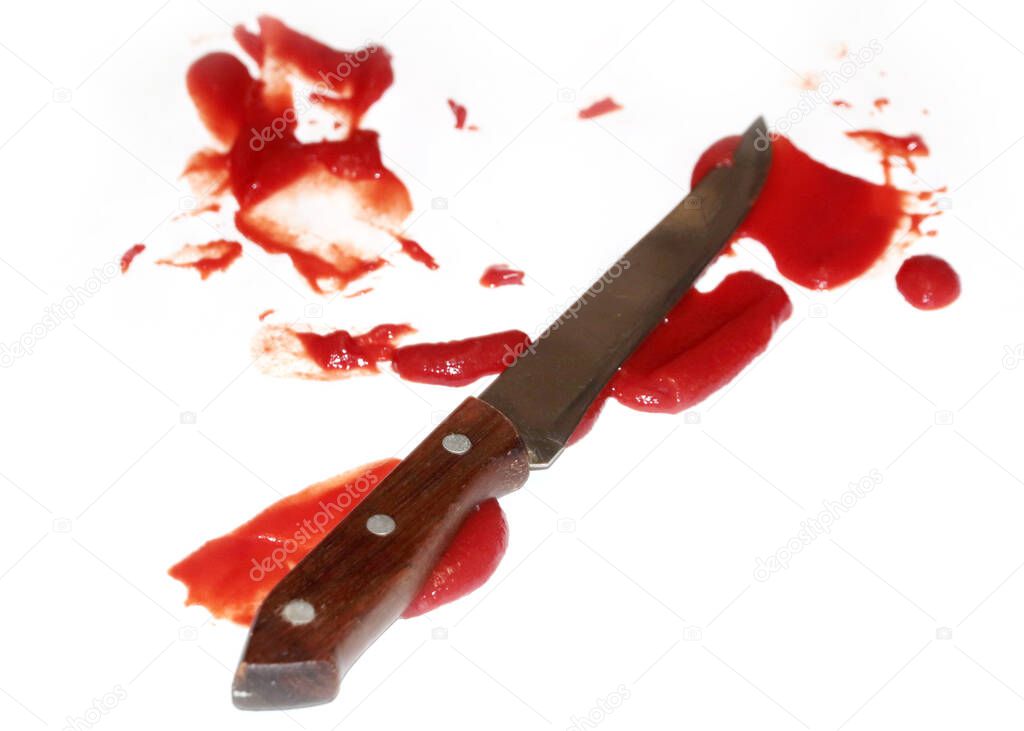 metal kitchen knife and drops of bloody mass as an illustration of domestic violence