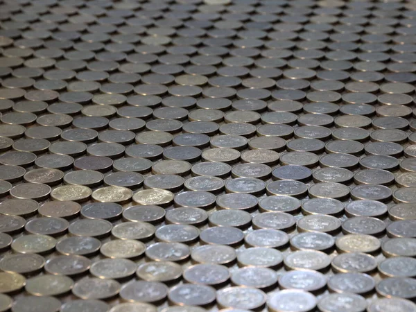 a plane of metal coins laid out in a row Russian ruble