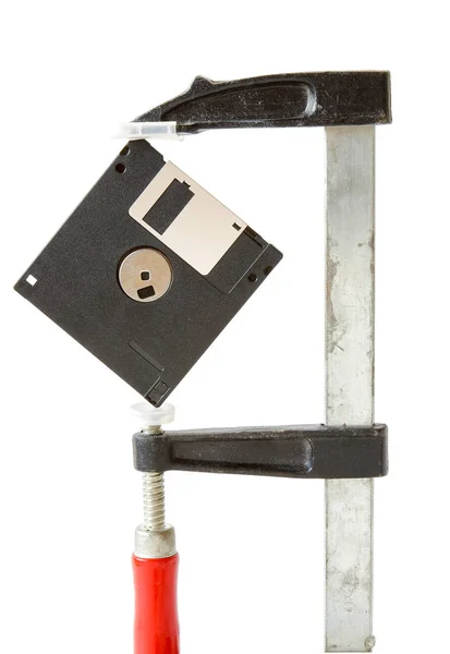 A floppy disk caught in carpentry clamps — Stock Photo, Image