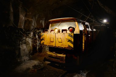 Service train inside mining quarry deep above Alps in Europe clipart