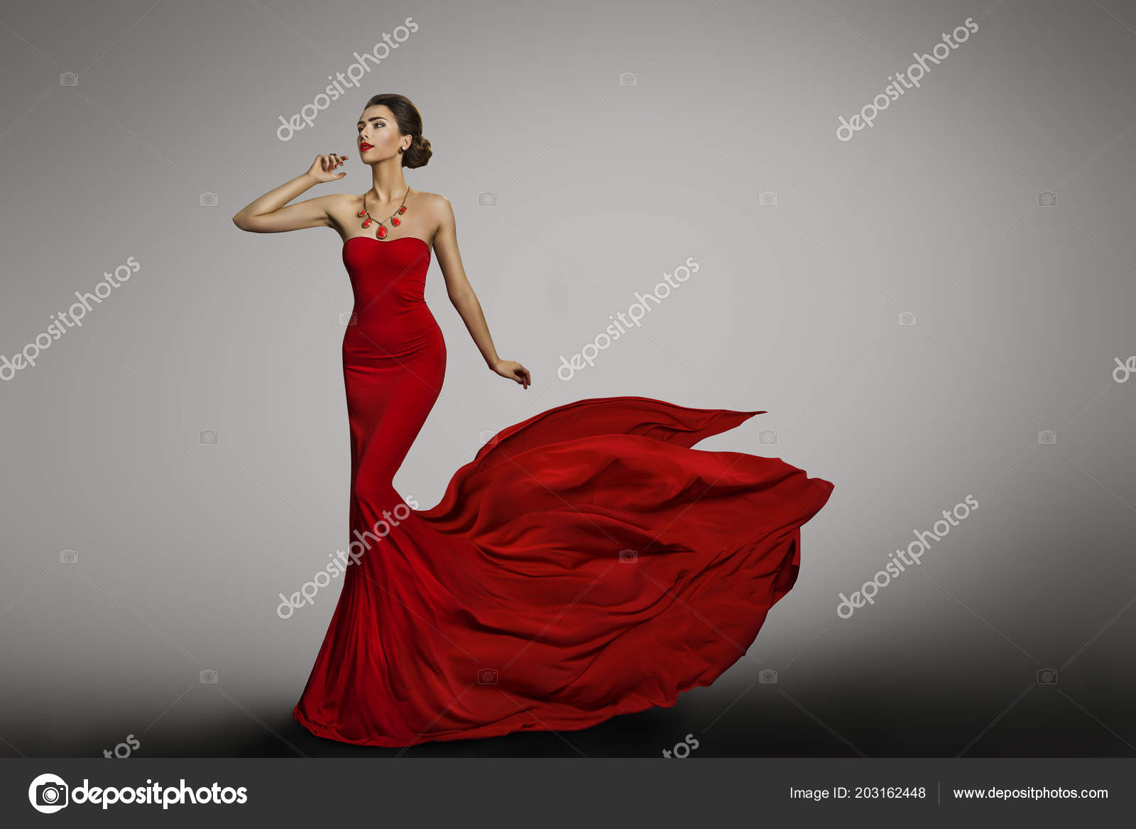 Premium Photo | A woman in a red dress is standing on a train tracks.