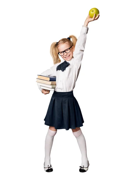 学校女孩 愉快的学生在制服与书上升苹果 滑稽的孩子全长画像被隔绝在白色背景之下 — 图库照片