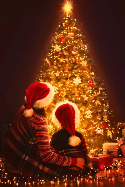 Natale famiglia cerca illuminazione albero di Natale, madre e bambino — Foto Stock