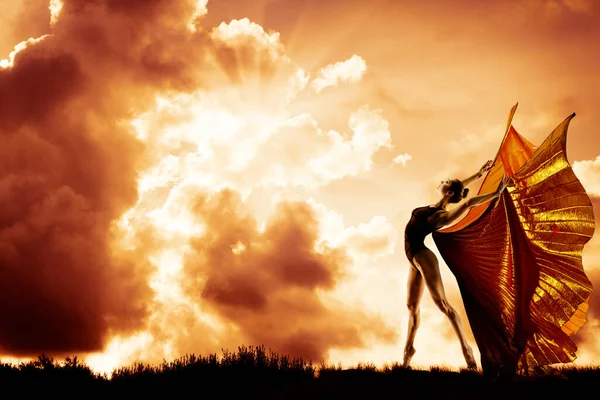 Woman Dance in Wings Costume Flying over Sunset Sky, Beautiful Girl Dancing in Sun Rays over Clouds Landscape