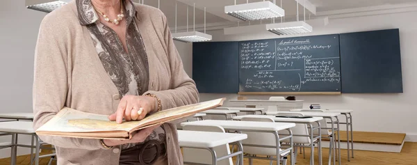 Ageing teacher in a classroom — Stock Photo, Image