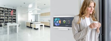 Modern bir evde ev otomasyon kontrol istasyonunda kahve içen bir kadın.