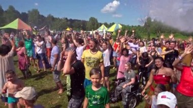 Barnaul, Rusya, 6 Temmuz 2019: sanat Yoga Festivali Rawa. Mutlu çocuklar ve yetişkinler zevk ve yaz gününde su akışı altında gülmek
