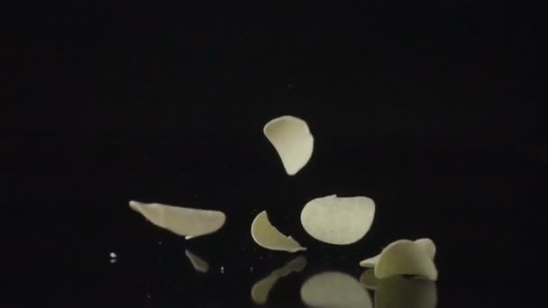 Falling Potato Chips Black Surface Shot High Speed Camera Slow — Stock Video