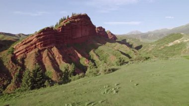 Red Clay Canyon Landscape. A breathtaking panoramic view of a dramatic  landscape, showcasing the vibrant hues of the eroded rock formations, lush green vegetation. Mountain canyon landscape. Drone view
