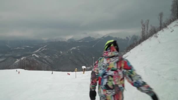 Grupp skidåkare och snowboardåkare rida upp kameran en efter en. Grupp vänner njuter av skidorten. Happy holidays på skidorten. — Stockvideo