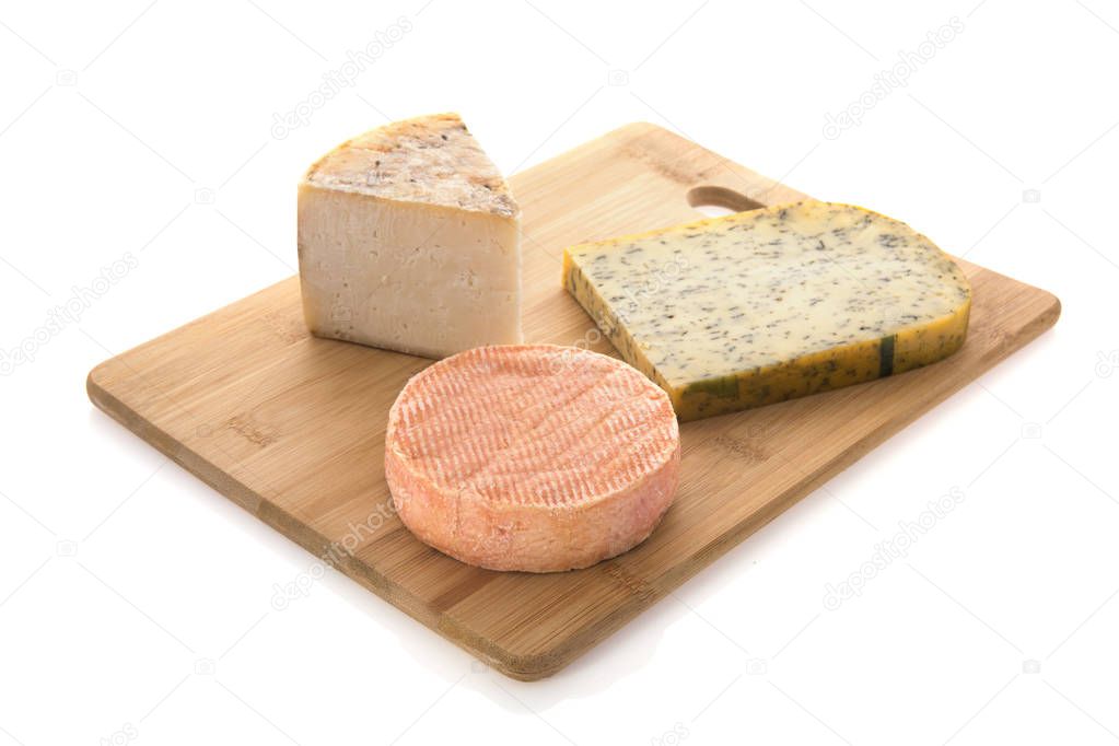 Assortment cheese on cutting board isolated over white background