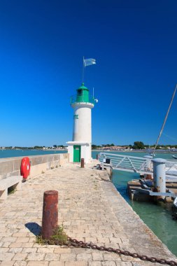 Ile de Re - Lighthouse and boats in the harbor of French village La Flotte clipart