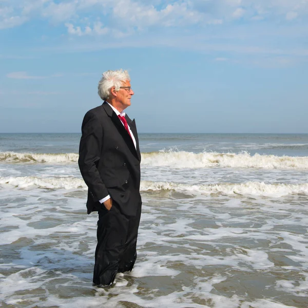 Obchodník stojící na pláži — Stock fotografie
