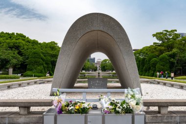 HIROSHIMA, JAPAN - JUEN 27 2017: Memorial Cenotaph in Hiroshima. At the center of the park, a monument covers a cenotaph holds the names of all people killed by the bomb. clipart