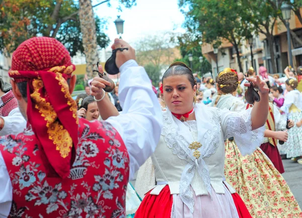 VALENCIA, SPAIN - NOVEMBER 9, 2014: traditional Valencian street party where inhabitants of all ages dance dressed in beautiful, original, handmade clothes and with typical hairstyle