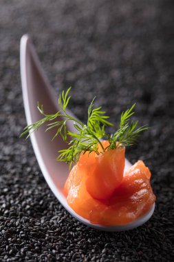 Tuzlanmış somon siyah susam arka plan üzerine dereotu ile dilim. Kopya alanı.