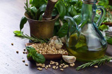 Zeytin yağı, sarımsak, yeşil fesleğen ve çam fıstığı ile eski bakır havan. .