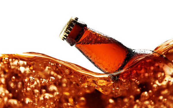 Wet  beer bottle isolated on a white background