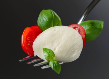  Kiraz domates ve fesleğen big çatal üzerinde mozzarella peyniri. Sağlıklı Akdeniz yemekleri.