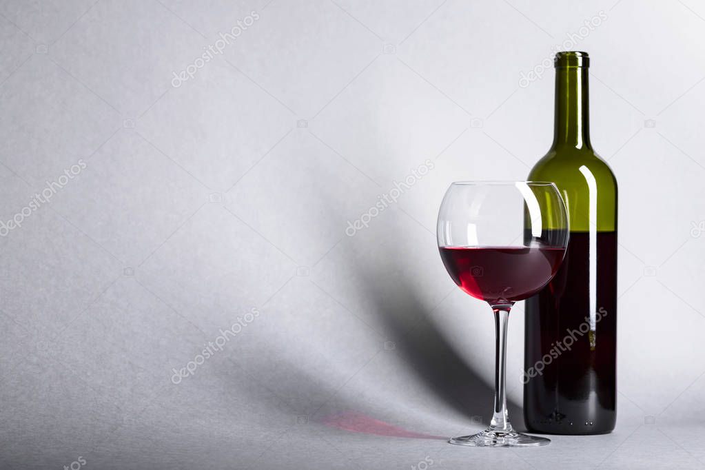 Glass and bottle of red wine, copy space for your text.