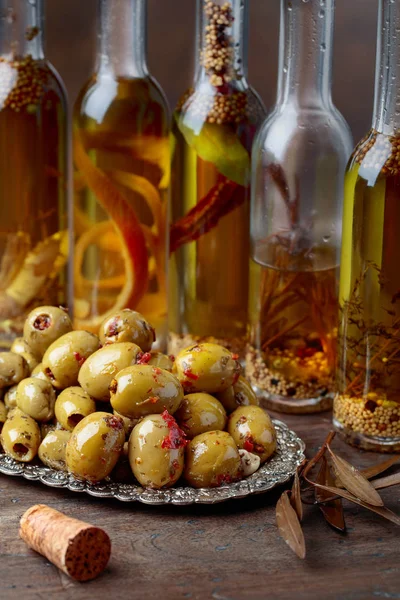 Spiced Green Olives Bottles Olive Oil Wooden Table — Stock Photo, Image