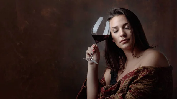 Portrait of a beautiful young woman with glass of red wine. Perfect makeup and hair. Model plus size. Copy space.
