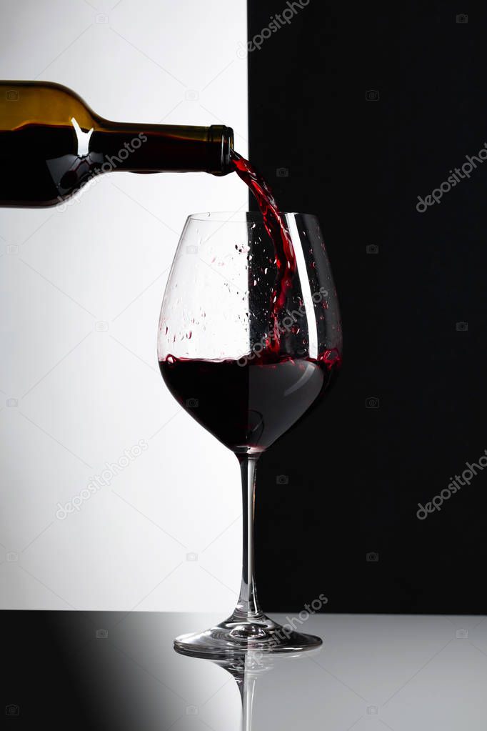 Red wine is poured into a glass.