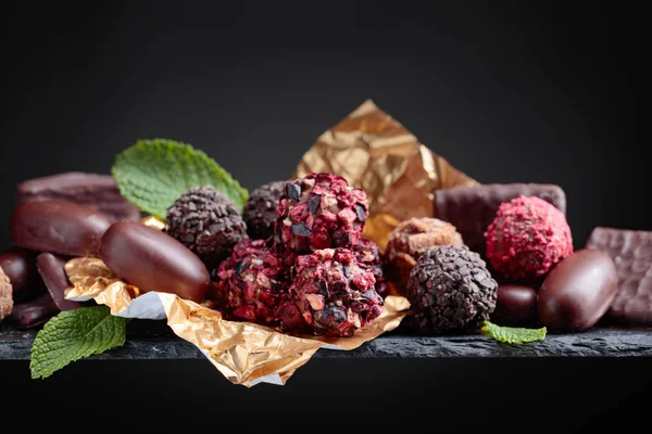 Various Chocolates Mint Leaves Black Background Copy Space — Stock Photo, Image