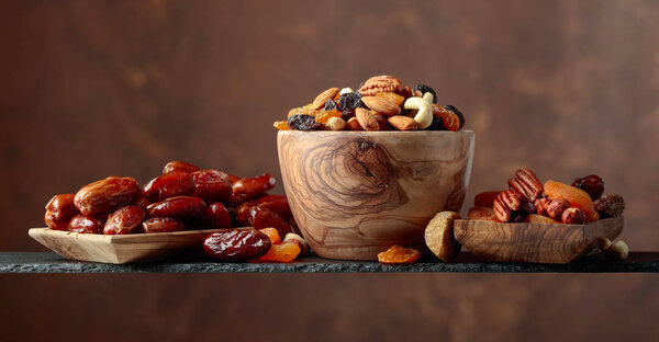 Various dried fruits and nuts in wooden dish. Copy space.