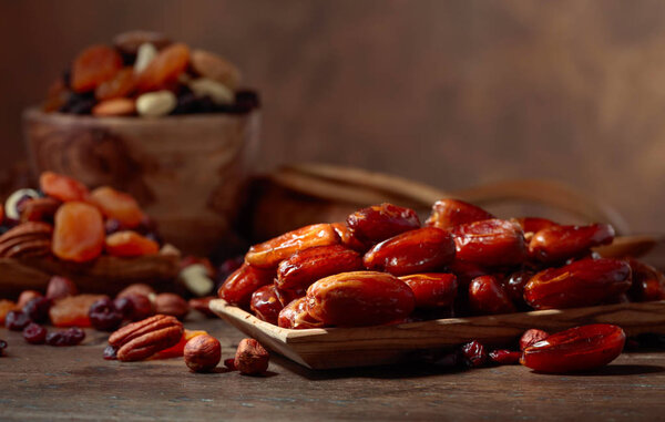 Various dried fruits and nuts on a old wooden table.