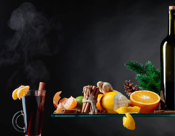 Mulled wine hot drink with citrus and spices. Copy space for your content.
