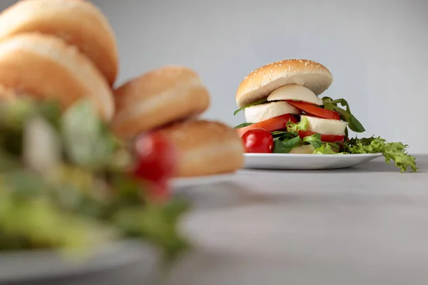 Sandwich with mozzarella, tomato and salad. — Stock Photo, Image