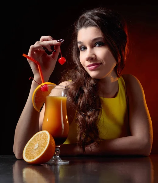 Ung vacker flicka med cocktail Tequila Sunrise. — Stockfoto