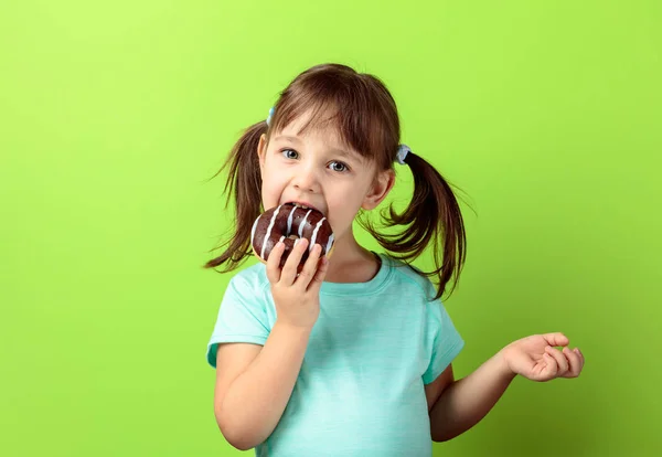 Four-year-old girl eat donut. — Stock Photo, Image