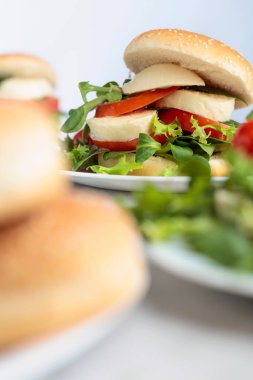 Mozzarella peyniri, domates, salata mutfak masasında ile sandviç.