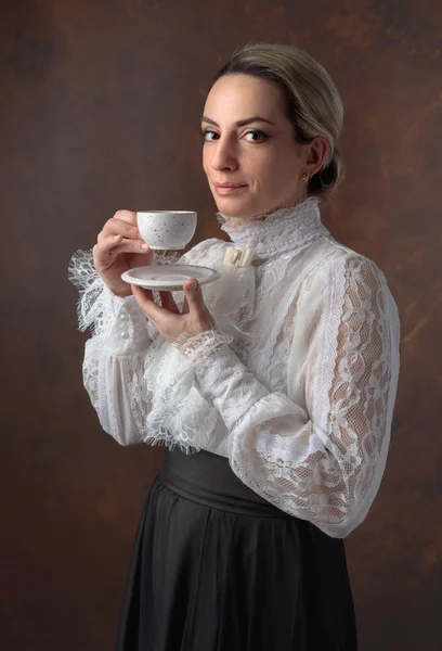 Πορτρέτο μιας γυναίκας στα ρούχα Βικτωριανής με ένα φλιτζάνι καφέ. — Φωτογραφία Αρχείου
